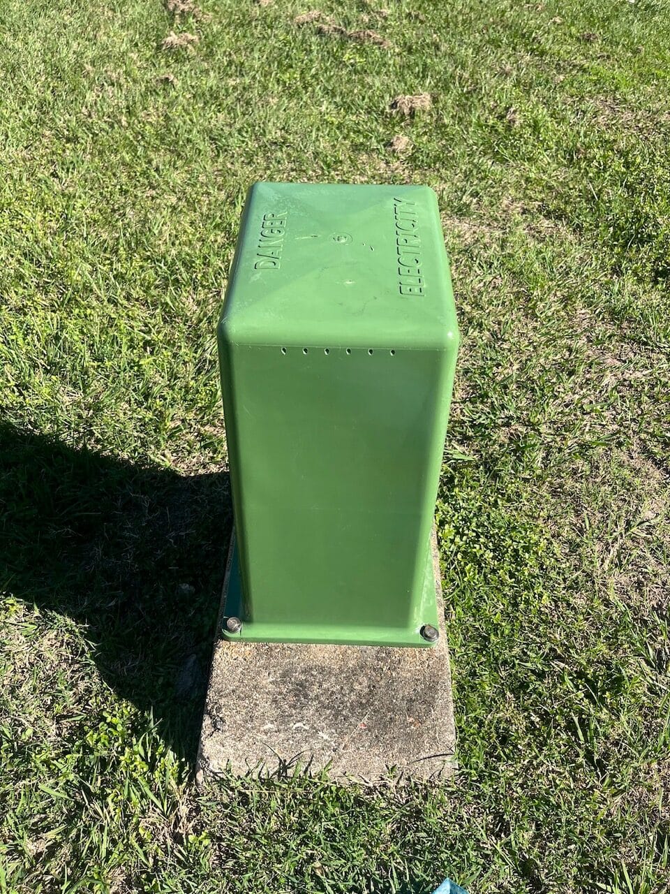 Green electrical box after graffiti removal